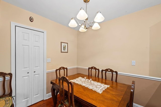 9437 Shore Rd Unit A1, New York City, NY 11209 - dining space featuring a chandelier, dark wood-style floors, and baseboards