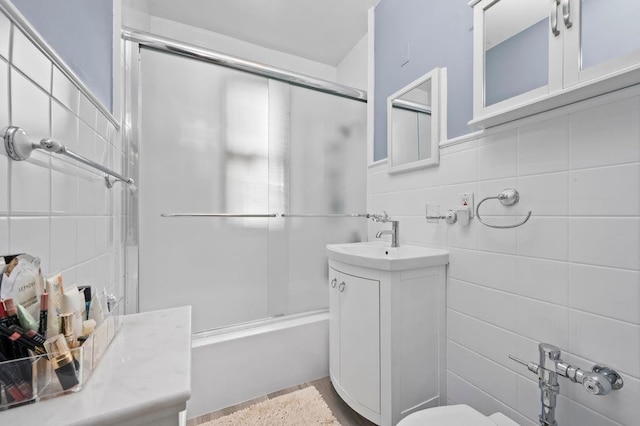 9437 Shore Rd Unit A1, New York City, NY 11209 - full bath featuring vanity, tile walls, combined bath / shower with glass door, and toilet