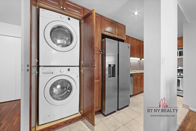 216 E 47th St Unit 4-A, New York City, NY 10017 - laundry area featuring stacked washer / dryer