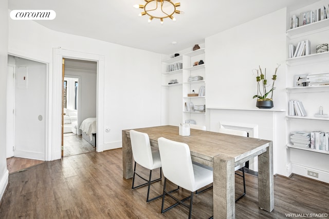 dining area with wood finished floors and a chandelier