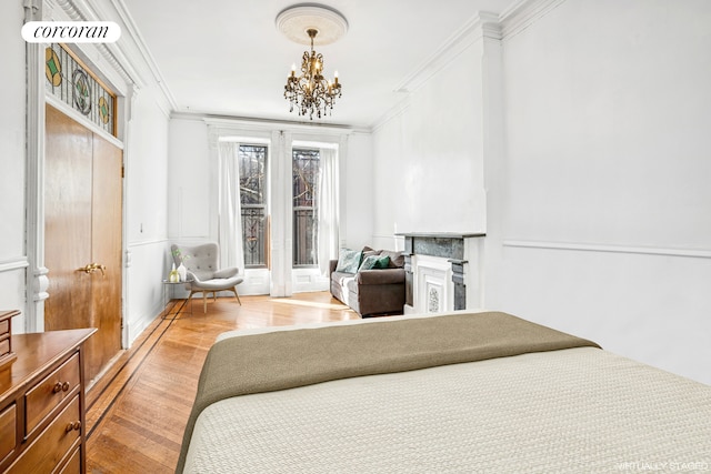 bedroom with ornamental molding, wood finished floors, and a chandelier