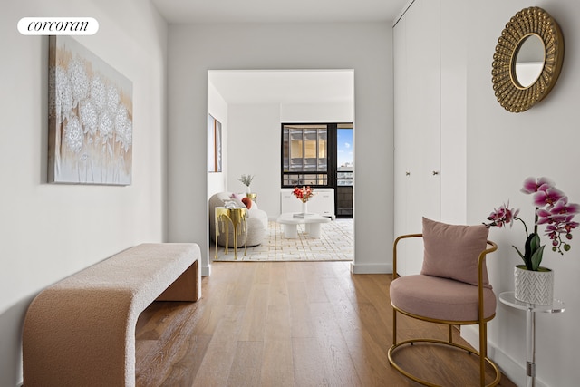 corridor with wood finished floors and baseboards