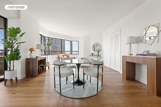dining room featuring wood finished floors and baseboards