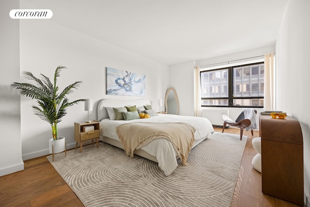 bedroom with wood finished floors and baseboards