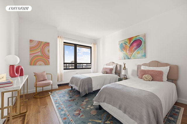 bedroom featuring wood finished floors and baseboards