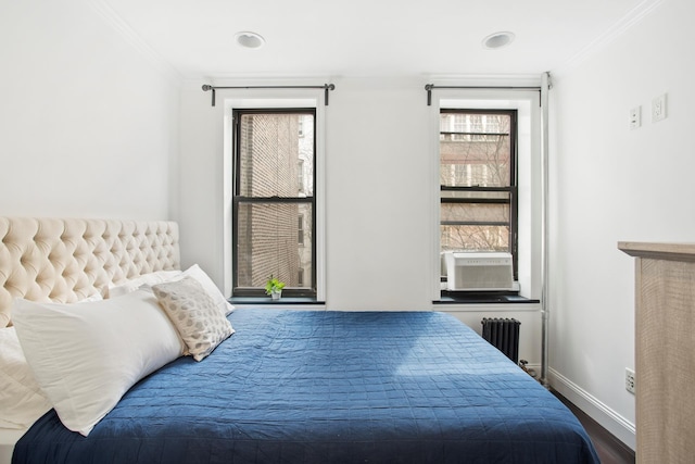 334 E 5th St Unit 3E, New York City, NY 10003 - bedroom with radiator heating unit, ornamental molding, baseboards, wood finished floors, and cooling unit