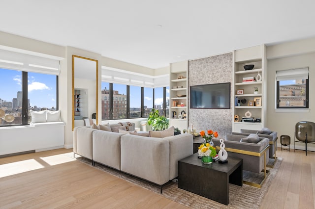 269 W 87th St Phb, Phb, New York City, NY 10024 - living area featuring a wealth of natural light, built in shelves, baseboards, and wood finished floors