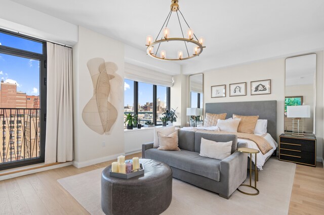 269 W 87th St Phb, Phb, New York City, NY 10024 - bedroom with a view of city, a notable chandelier, light wood-type flooring, and baseboards