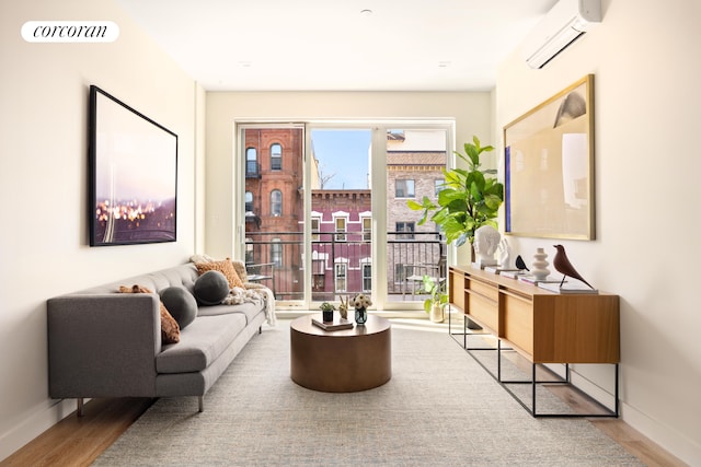 1122 Lafayette Ave Unit 3A, New York City, NY 11221 - sitting room with a wall mounted air conditioner, wood finished floors, and baseboards