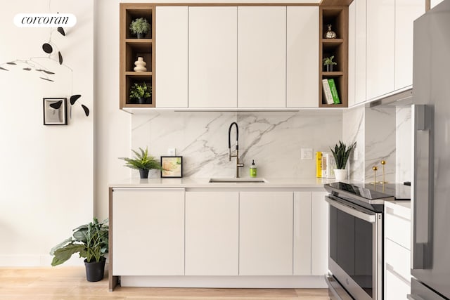 1122 Lafayette Ave Unit 3A, New York City, NY 11221 - kitchen featuring open shelves, appliances with stainless steel finishes, a sink, and modern cabinets