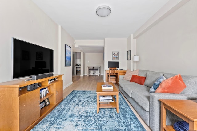 living room with light wood-style flooring and baseboards