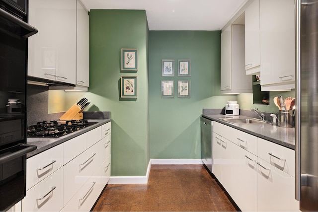 kitchen with white cabinets, dark countertops, a sink, baseboards, and black appliances
