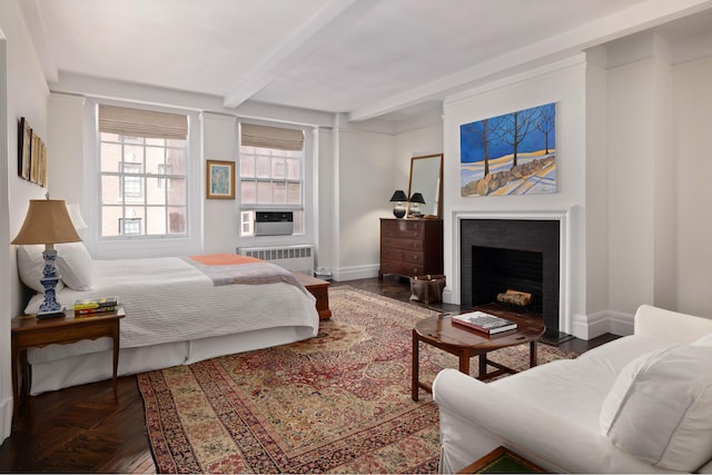 bedroom featuring radiator, a fireplace with flush hearth, beam ceiling, cooling unit, and baseboards