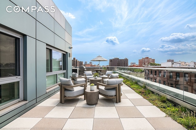 view of patio with a city view and a balcony