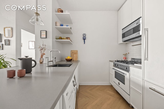184 Kent Ave Unit A617, New York City, NY 11249 - kitchen with stainless steel microwave, high end white range oven, a sink, white cabinets, and tasteful backsplash