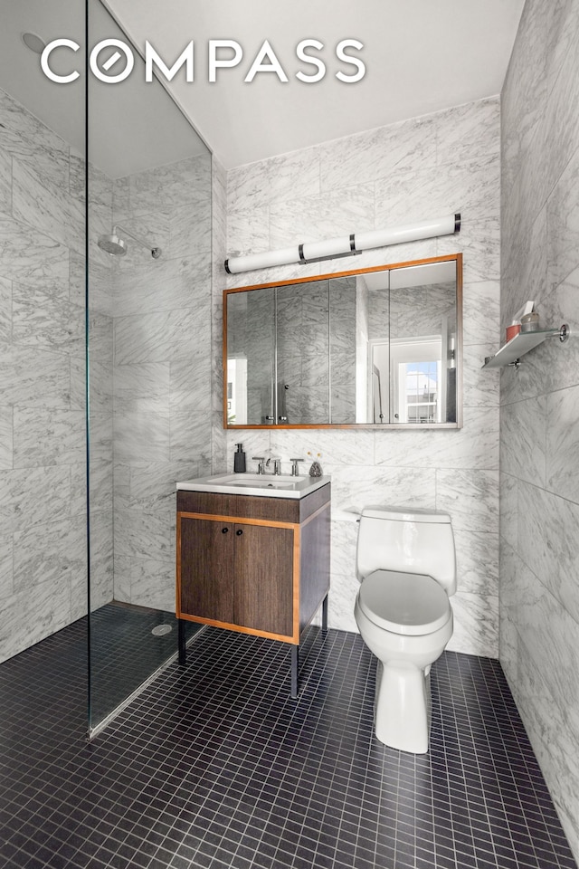 184 Kent Ave Unit A617, New York City, NY 11249 - full bathroom with tile walls, walk in shower, toilet, vanity, and tile patterned flooring