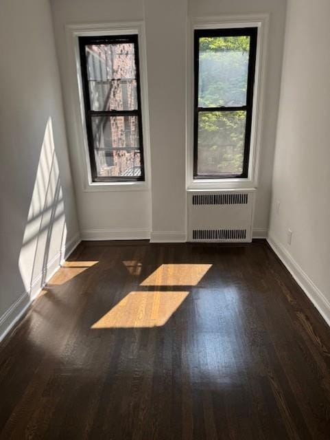 2515 Glenwood Rd Unit 2E, New York City, NY 11210 - unfurnished room featuring radiator, wood finished floors, and baseboards