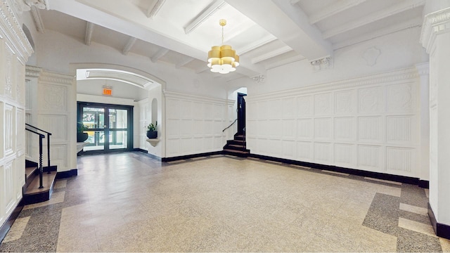 2515 Glenwood Rd Unit 2E, New York City, NY 11210 - building lobby featuring a decorative wall, beamed ceiling, and stairs