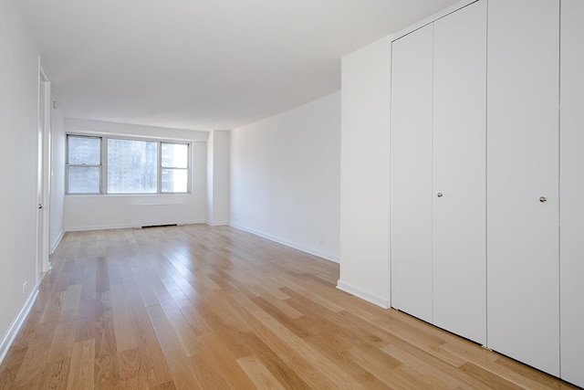 300 E 40th St Unit 23-G, New York City, NY 10016 - unfurnished bedroom with light wood-type flooring and baseboards