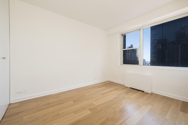 300 E 40th St Unit 23-G, New York City, NY 10016 - unfurnished room featuring light wood finished floors and baseboards
