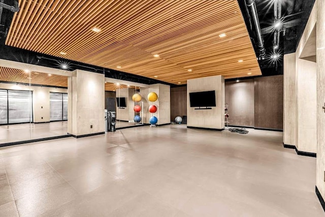 interior space featuring wood ceiling and baseboards