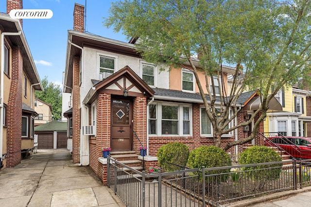 view of front facade featuring stucco siding, a chimney, brick siding, entry steps, and a fenced front yard