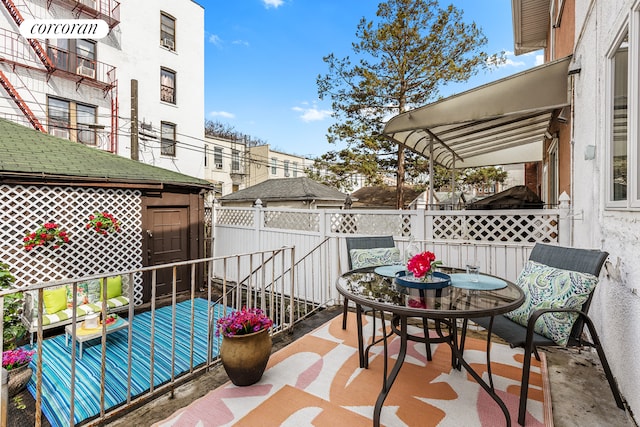 view of patio with fence and outdoor dining area