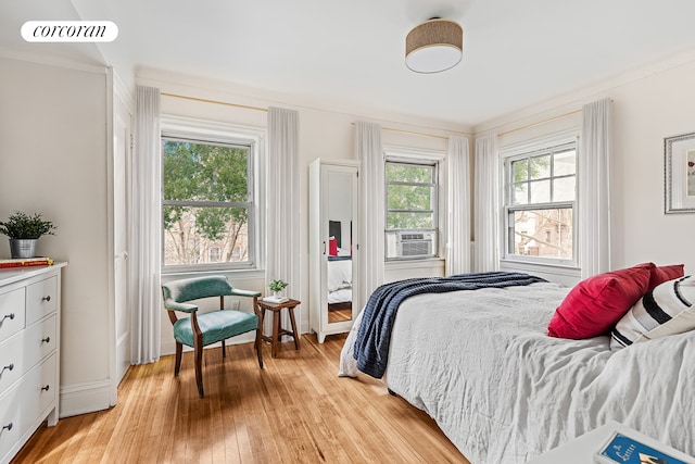 bedroom featuring access to outside, cooling unit, baseboards, light wood-type flooring, and visible vents