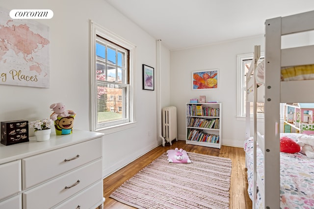 interior space with baseboards, light wood finished floors, and radiator heating unit
