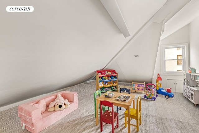 rec room featuring carpet floors and vaulted ceiling