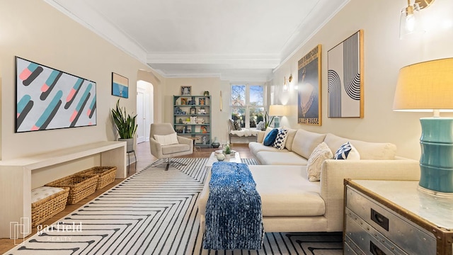 living area with crown molding and arched walkways
