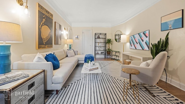 sitting room with crown molding, baseboards, and wood finished floors
