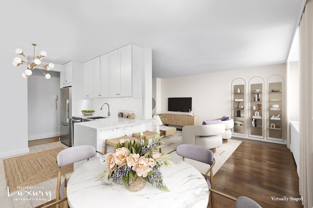 30 W 61st St Unit 24C, New York City, NY 10023 - dining space with wood finished floors, a chandelier, and baseboards