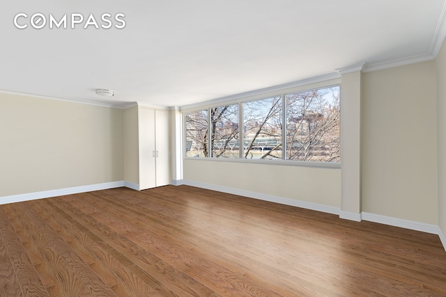 551 Main St Unit 208, New York City, NY 10044 - spare room with plenty of natural light, wood finished floors, baseboards, and ornamental molding