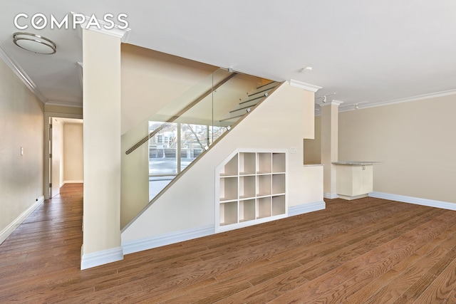 551 Main St Unit 208, New York City, NY 10044 - staircase featuring crown molding, wood finished floors, and baseboards