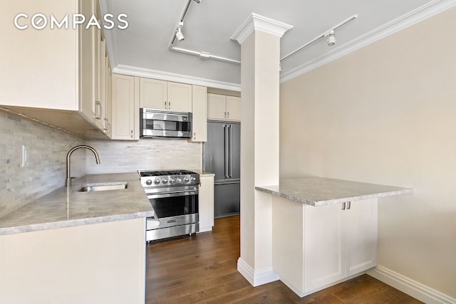 551 Main St Unit 208, New York City, NY 10044 - kitchen with premium appliances, track lighting, a sink, light countertops, and tasteful backsplash