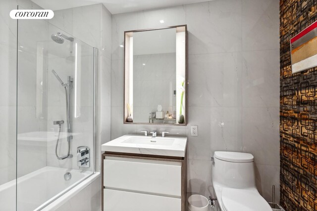 505 W 43rd St Unit 6K, New York City, NY 10036 - full bathroom with vanity, washtub / shower combination, toilet, and tile walls