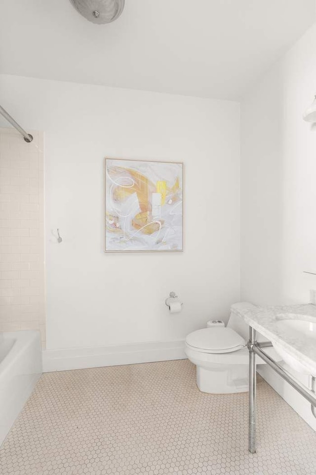 1 Main St Unit 7H, New York City, NY 11201 - full bathroom featuring toilet, baseboards, tile patterned flooring, and shower / bathing tub combination