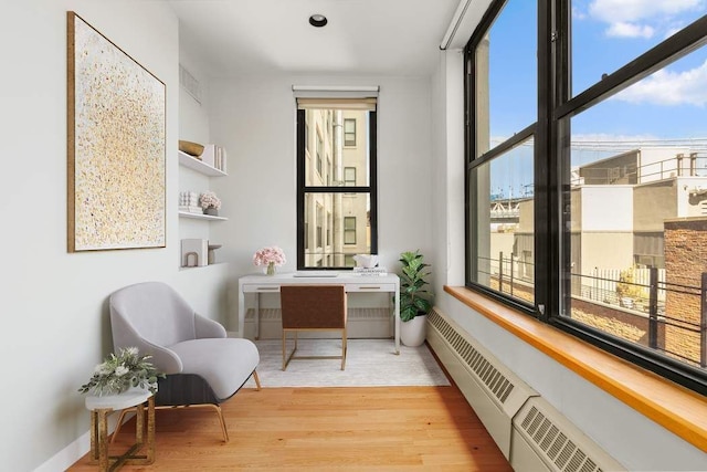1 Main St Unit 7H, New York City, NY 11201 - living area featuring wood finished floors, baseboards, and visible vents