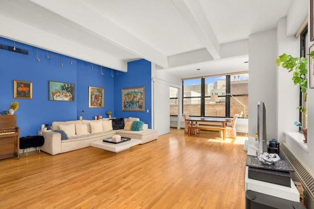 1 Main St Unit 7H, New York City, NY 11201 - living area featuring light wood-style flooring and beam ceiling