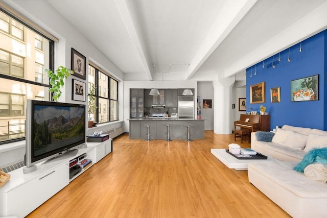 1 Main St Unit 7H, New York City, NY 11201 - living room with beamed ceiling and light wood finished floors
