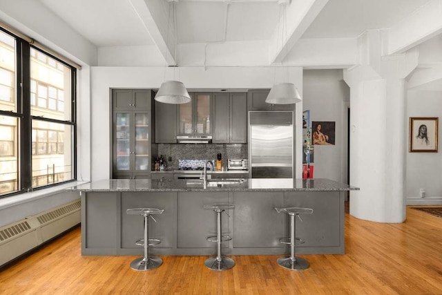 1 Main St Unit 7H, New York City, NY 11201 - kitchen with a sink, a wealth of natural light, built in fridge, under cabinet range hood, and gray cabinetry