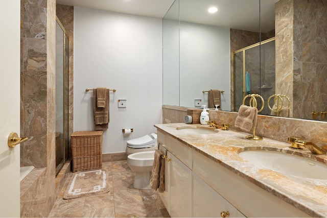 bathroom with a stall shower, a bidet, toilet, marble finish flooring, and double vanity