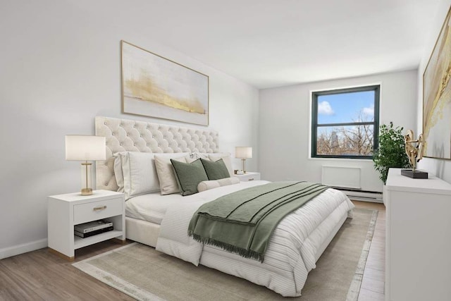 379 W St Unit 2B, New York City, NY 10014 - bedroom with baseboards, a baseboard radiator, and wood finished floors