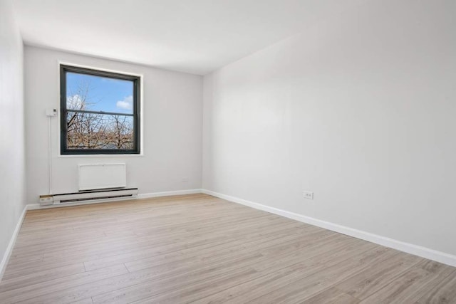 379 W St Unit 2B, New York City, NY 10014 - empty room with baseboards, baseboard heating, and light wood finished floors