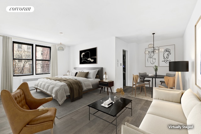 330 E 80th St Unit 3K, New York City, NY 10075 - bedroom with radiator, wood finished floors, a chandelier, and baseboards