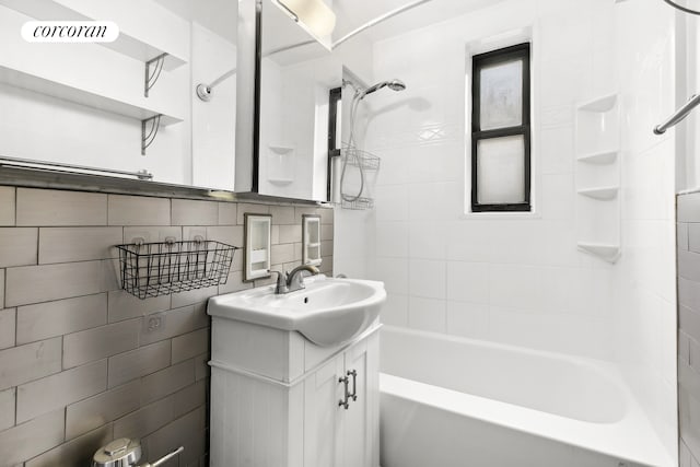 330 E 80th St Unit 3K, New York City, NY 10075 - bathroom featuring tile walls, vanity, and bathtub / shower combination