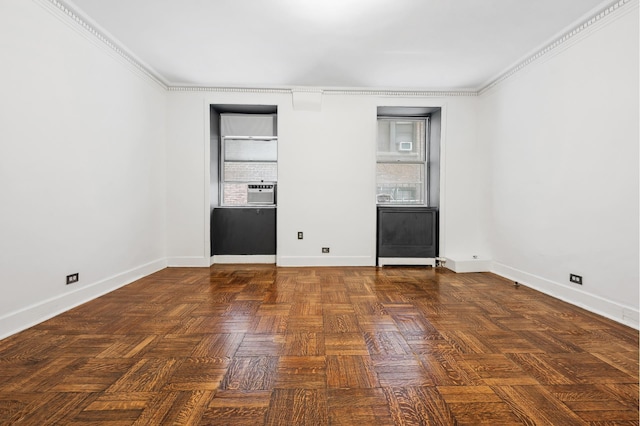 empty room with healthy amount of natural light, baseboards, and crown molding