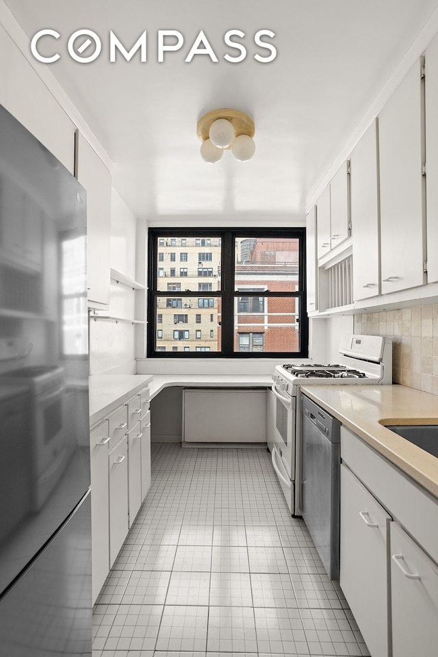 kitchen with open shelves, stainless steel appliances, light countertops, backsplash, and light tile patterned floors