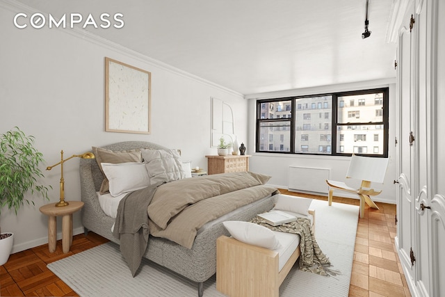 bedroom with ornamental molding and baseboards